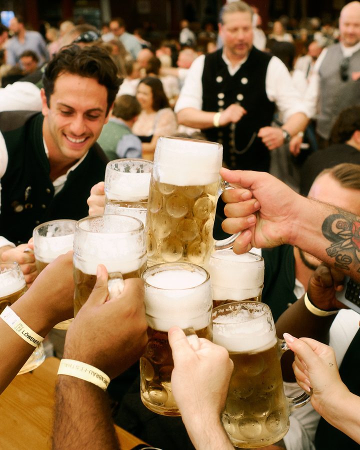 Raising beer steins in the festival tent
