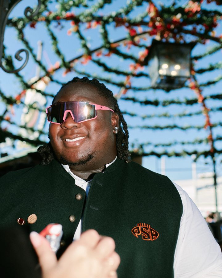 Team member in a PSA vest under the floral canopy